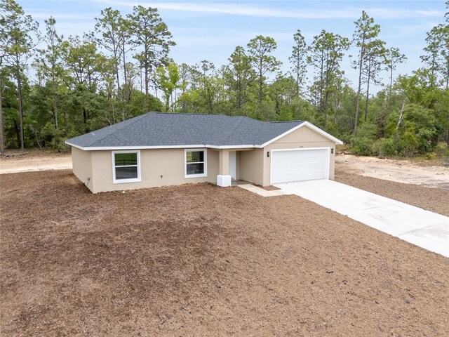 23131 SW Rainelle Rd, Dunnellon, FL 34431 - single story home featuring an attached garage, concrete driveway, and stucco siding