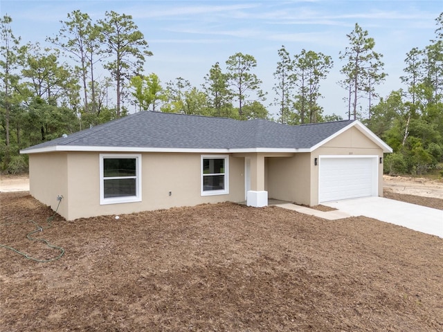 23131 SW Rainelle Rd, Dunnellon, FL 34431 - ranch-style home with an attached garage, a shingled roof, concrete driveway, and stucco siding