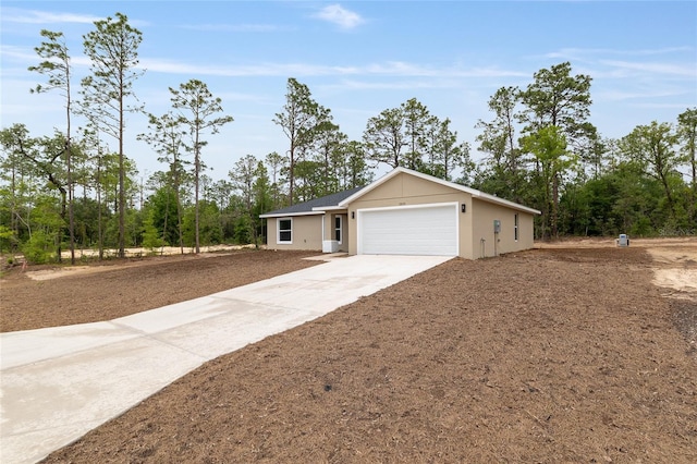 23131 SW Rainelle Rd, Dunnellon, FL 34431 - ranch-style home featuring an attached garage, driveway, and stucco siding