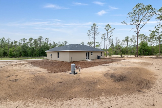 23131 SW Rainelle Rd, Dunnellon, FL 34431 - rear view of property with fence and stucco siding