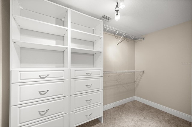 walk in closet with carpet