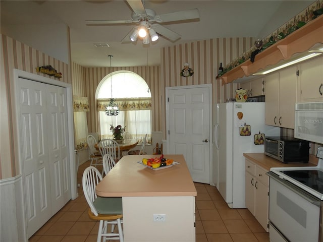 kitchen featuring wallpapered walls, light tile patterned flooring, ceiling fan with notable chandelier, and white appliances