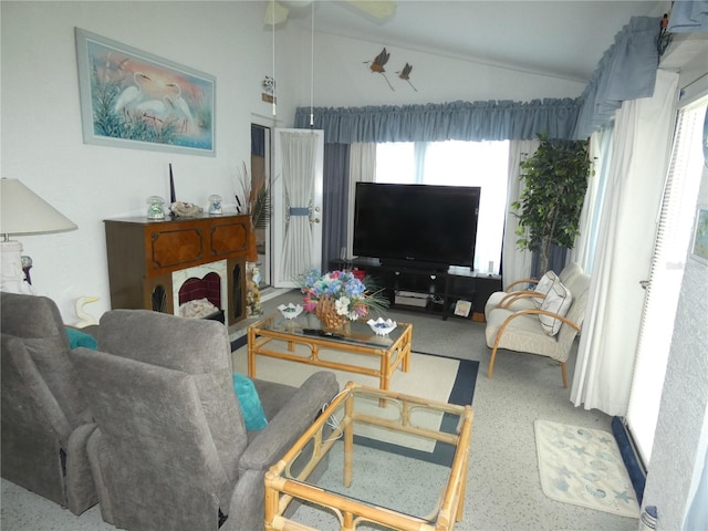 living area featuring lofted ceiling and ceiling fan