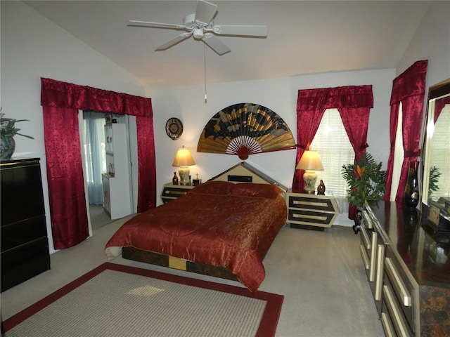 bedroom with lofted ceiling, carpet floors, and a ceiling fan
