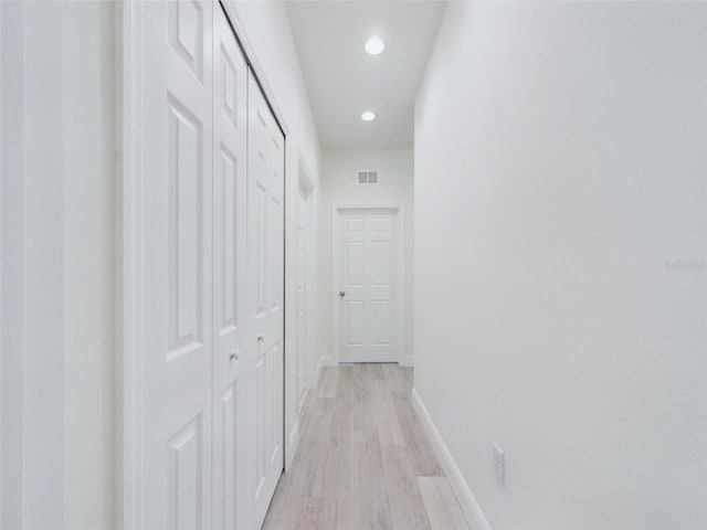 corridor with recessed lighting, baseboards, visible vents, and light wood-style floors