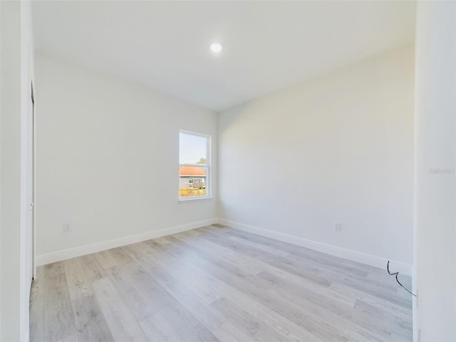 unfurnished room with light wood-style floors, baseboards, and recessed lighting