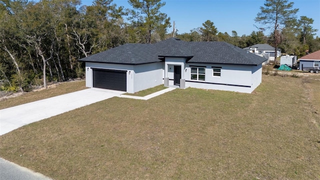 view of front of property with stucco siding, a garage, a front lawn, and driveway