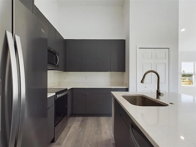 4415 SW 169th Lane Rd, Ocala, FL 34473 - kitchen featuring a sink, light wood-style flooring, modern cabinets, and appliances with stainless steel finishes