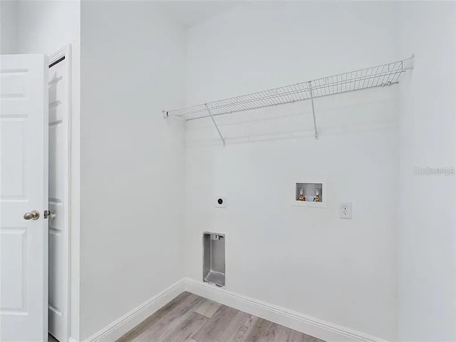 4415 SW 169th Lane Rd, Ocala, FL 34473 - washroom featuring light wood finished floors, laundry area, hookup for an electric dryer, hookup for a washing machine, and baseboards