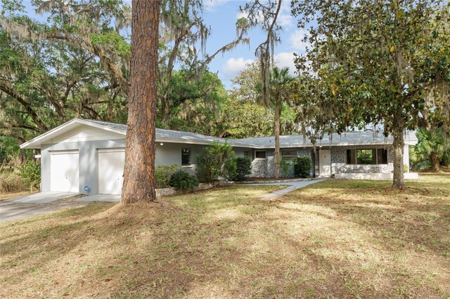 single story home with driveway and a front yard