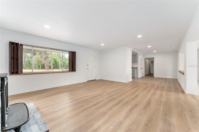 unfurnished living room featuring light wood-style flooring, baseboards, and recessed lighting
