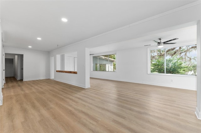 unfurnished living room featuring baseboards, light wood-style flooring, and recessed lighting
