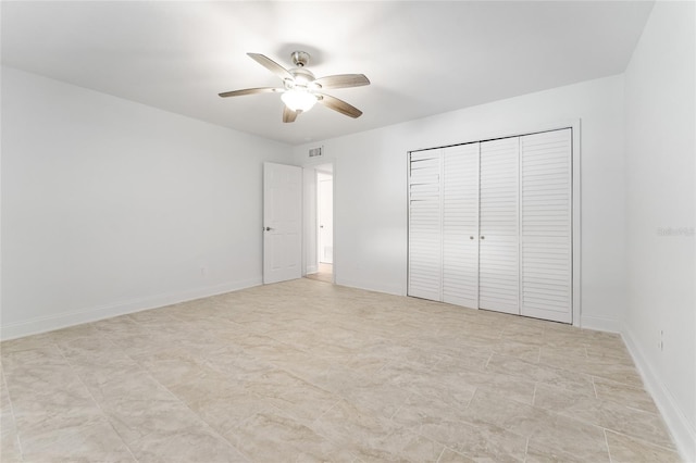unfurnished bedroom featuring a ceiling fan, baseboards, a closet, and visible vents