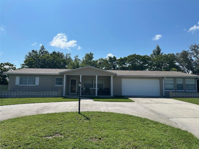 79 S Harrison St, Beverly Hills, FL 34465 - ranch-style house with concrete driveway, a front yard, an attached garage, and covered porch
