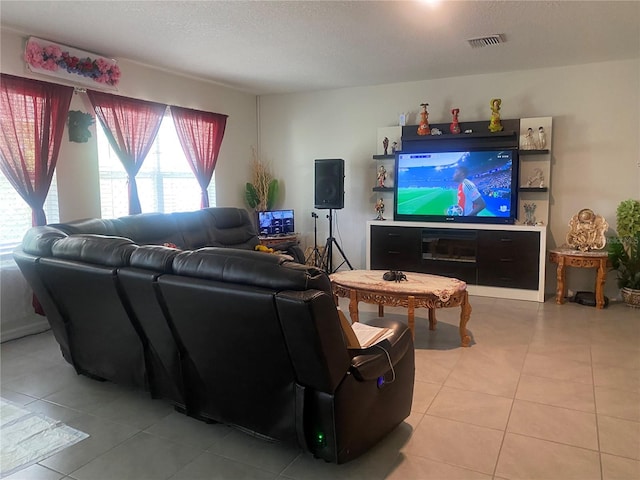 living area with light tile patterned floors and a textured ceiling