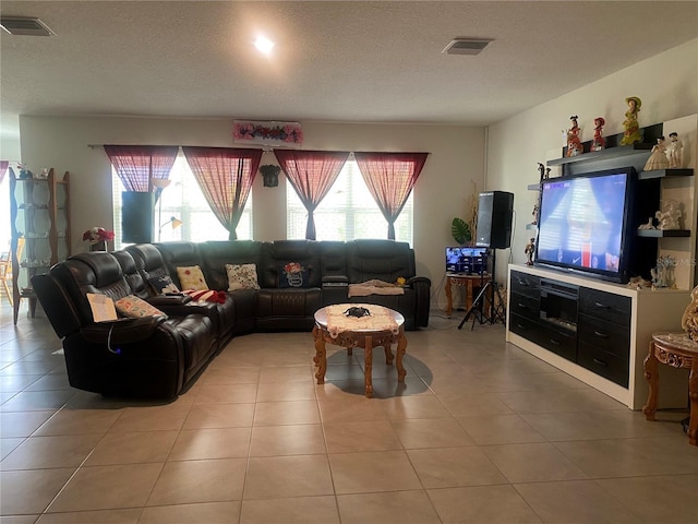 living room with light tile patterned floors and a textured ceiling