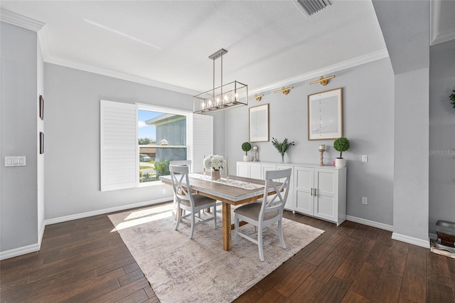 dining area featuring crown molding, dark wood-style floors, baseboards, and a chandelier