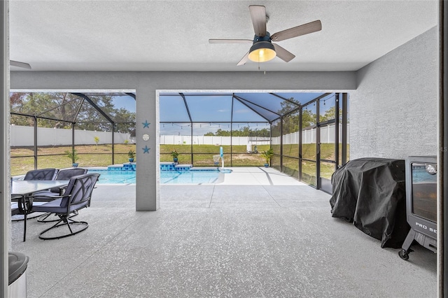 view of patio with a lanai and a ceiling fan