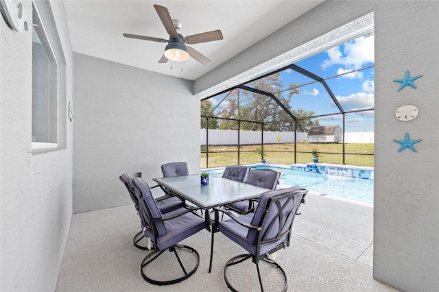 view of patio featuring ceiling fan, outdoor dining area, and a lanai