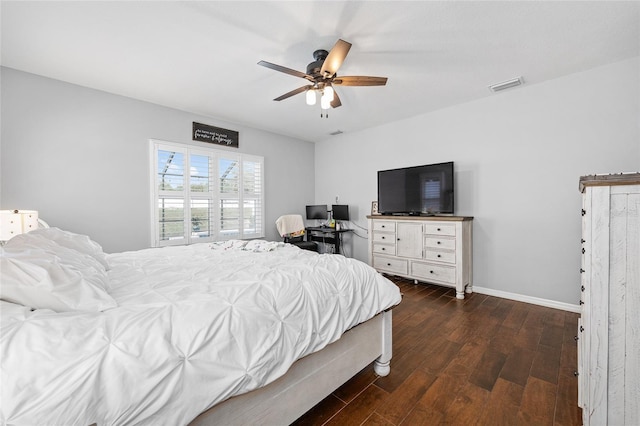 bedroom featuring dark wood-style flooring, a ceiling fan, and baseboards