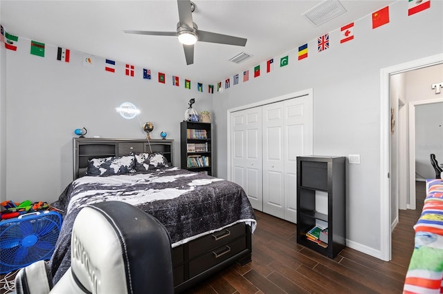 bedroom with dark wood-style floors, a closet, baseboards, and ceiling fan