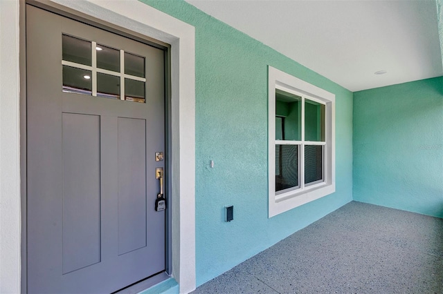 view of exterior entry with stucco siding