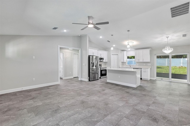 kitchen with lofted ceiling, stainless steel appliances, visible vents, open floor plan, and a center island