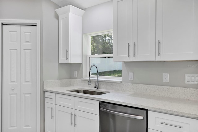 kitchen featuring white cabinetry, light stone countertops, a sink, and dishwasher