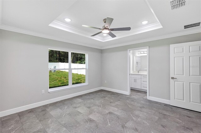 unfurnished bedroom with crown molding, visible vents, baseboards, and a raised ceiling