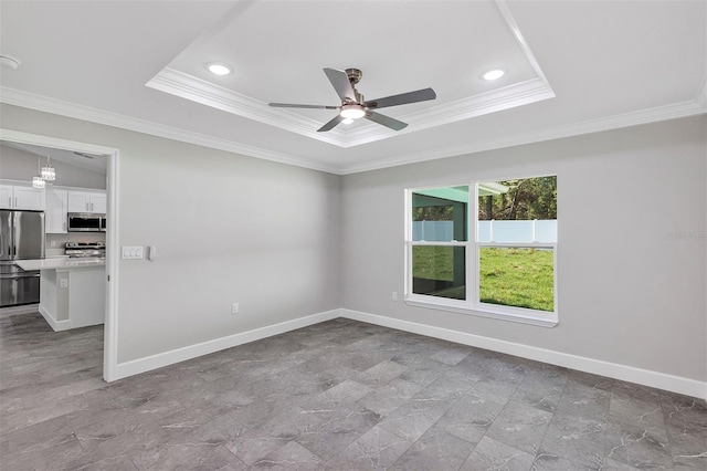 unfurnished room featuring ornamental molding, recessed lighting, ceiling fan, a tray ceiling, and baseboards