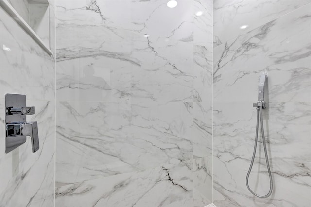 room details featuring a marble finish shower