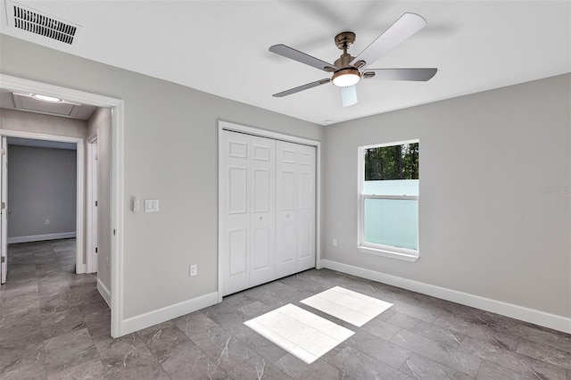 unfurnished bedroom with a closet, visible vents, and baseboards