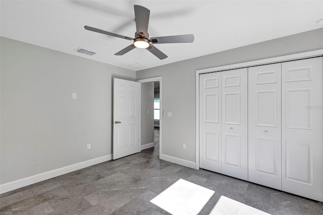 unfurnished bedroom featuring a closet, visible vents, baseboards, and ceiling fan