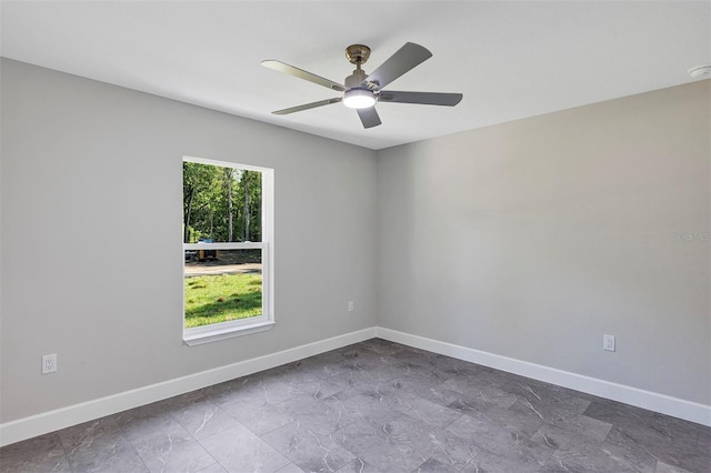unfurnished room featuring baseboards and ceiling fan