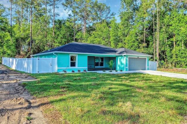 single story home featuring driveway, fence, an attached garage, stucco siding, and a front yard