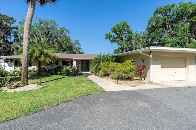 414 NW 8th Ave, Crystal River, FL 34428 - ranch-style home featuring a garage, a front lawn, and driveway