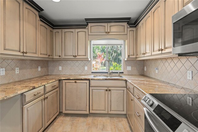 414 NW 8th Ave, Crystal River, FL 34428 - kitchen with appliances with stainless steel finishes, a sink, light stone countertops, and backsplash