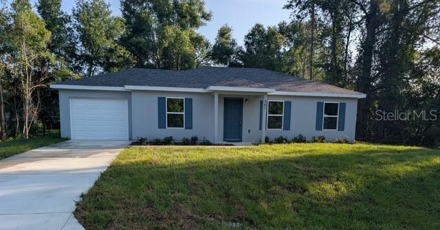 267 Oak Lane Trak, Ocala, FL 34472 - ranch-style home featuring an attached garage, stucco siding, driveway, and a front yard