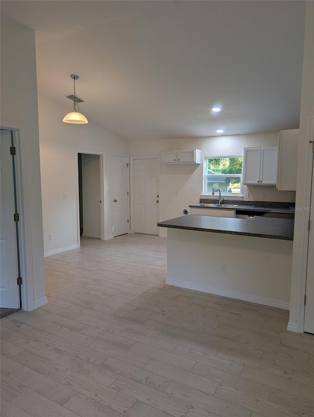 267 Oak Lane Trak, Ocala, FL 34472 - kitchen featuring white cabinets, dark countertops, and light wood finished floors