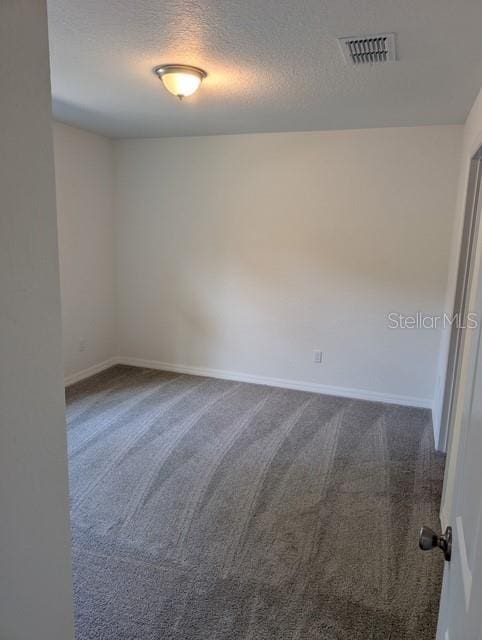 267 Oak Lane Trak, Ocala, FL 34472 - empty room featuring dark colored carpet, a textured ceiling, baseboards, and visible vents