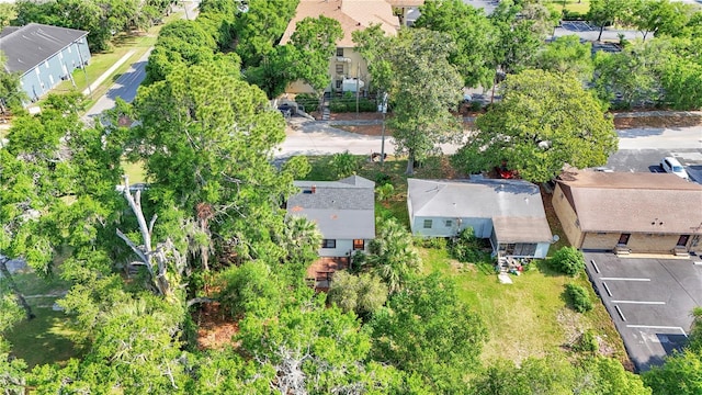 aerial view of property's location featuring nearby suburban area and a tree filled landscape