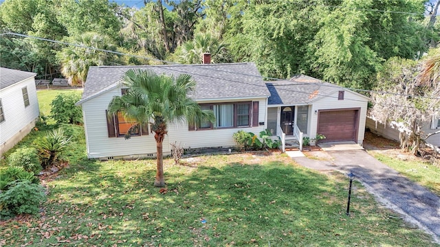 single story home featuring an attached garage, roof with shingles, asphalt driveway, and a front lawn
