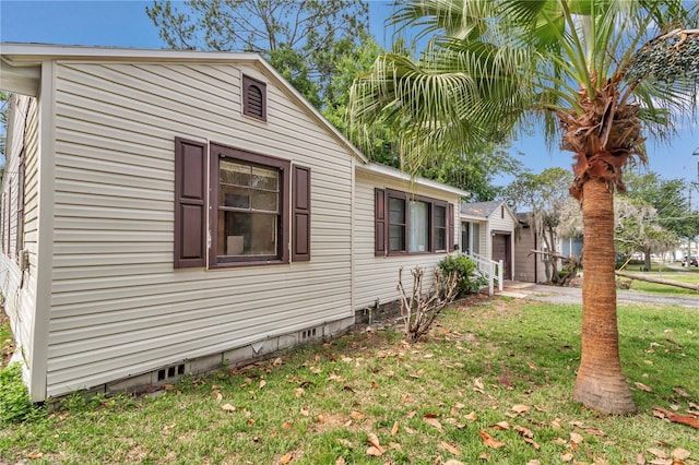 view of side of home featuring a lawn