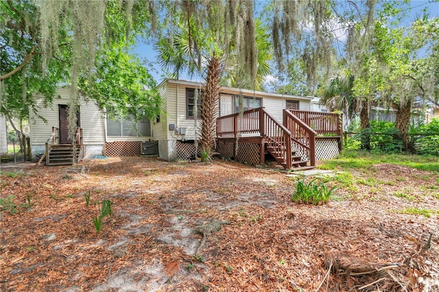 back of property featuring a wooden deck, central AC, and stairs