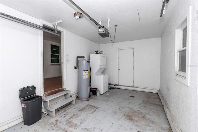 garage with stacked washer / drying machine, electric water heater, and a garage door opener