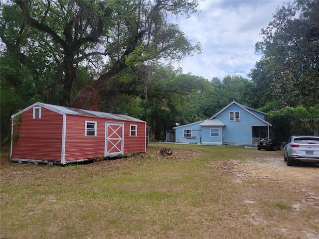 view of yard featuring a storage shed and an outdoor structure