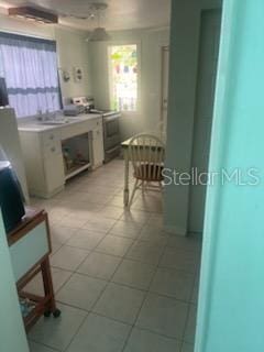 kitchen with light tile patterned flooring