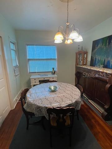 dining area featuring a chandelier and dark wood-type flooring