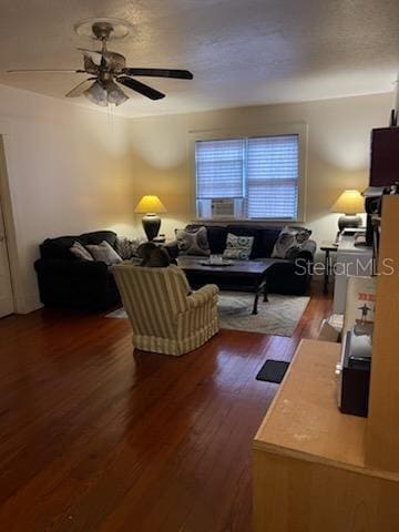 living area featuring a ceiling fan and dark wood finished floors