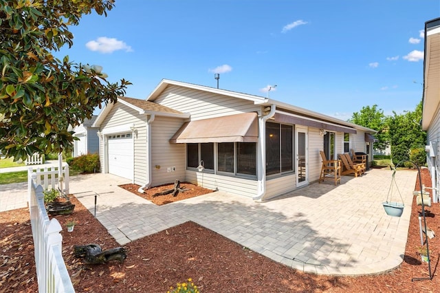1736 Watts Mill Way, The Villages, FL 32162 - back of house featuring an attached garage and a sunroom